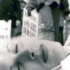 Alice O’Malley (born 1962), “New Yorkers Demand”—Chloe Dzubilo, ACT UP Die-in, NYC c. 1994, printed 2015. Gelatin silver print, 20 × 16 inches. Courtesy of the artist.