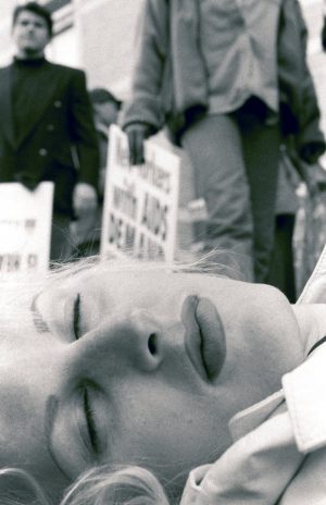 Alice O’Malley (born 1962), “New Yorkers Demand”—Chloe Dzubilo, ACT UP Die-in, NYC c. 1994, printed 2015. Gelatin silver print, 20 × 16 inches. Courtesy of the artist.